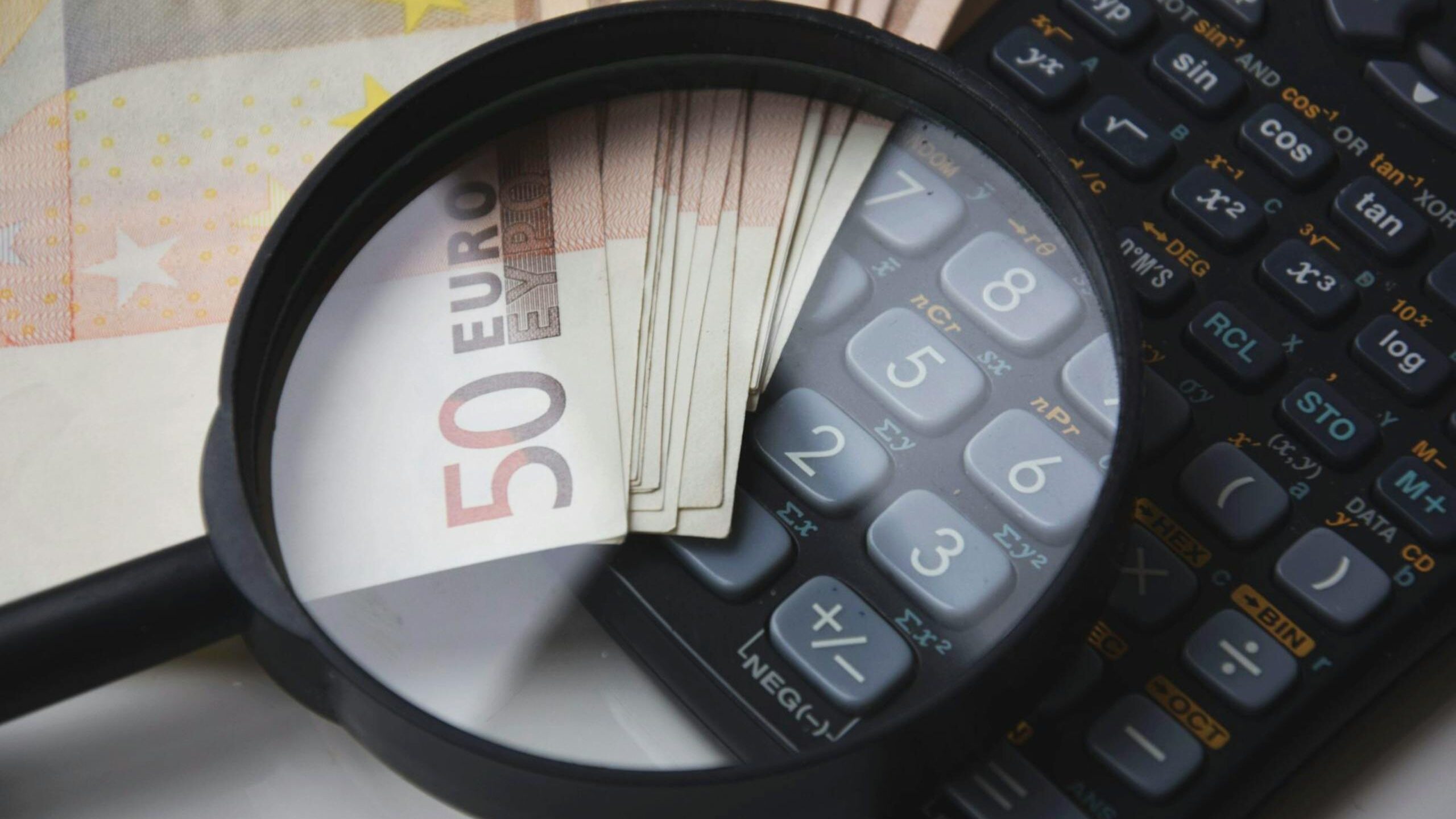 Euro notes and a calculator for working out VAT